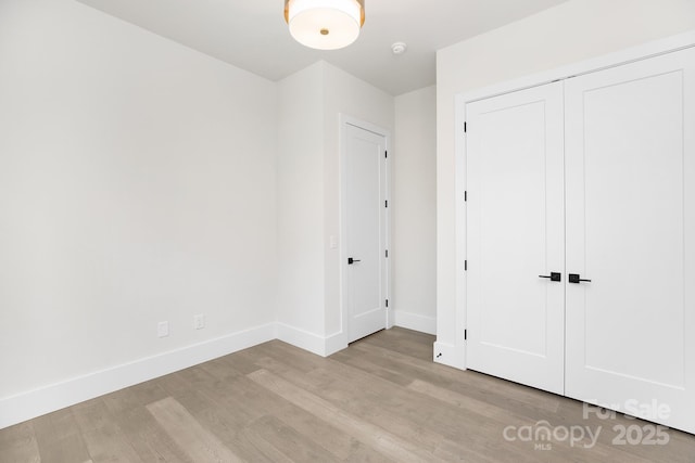 1534 Easy St, Belmont, NC 28012 - unfurnished bedroom featuring light wood-style floors, baseboards, and a closet