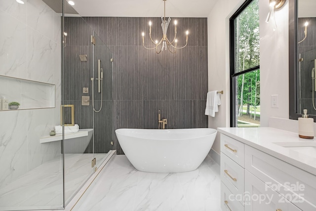 1534 Easy St, Belmont, NC 28012 - bathroom featuring a shower stall, marble tiled floors, a freestanding tub, vanity, and tile walls