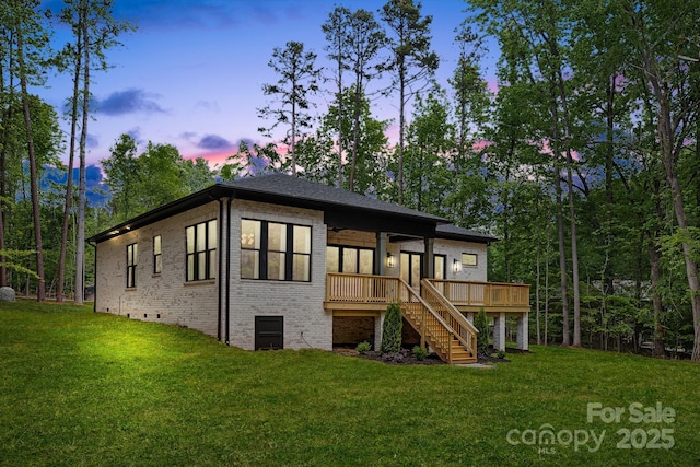 1534 Easy St, Belmont, NC 28012 - back of house featuring stairs, brick siding, a wooden deck, and a lawn