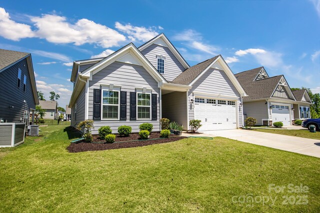 5112 Larewood Dr, Charlotte, NC 28215 - craftsman-style house featuring an attached garage, central air condition unit, driveway, and a front yard
