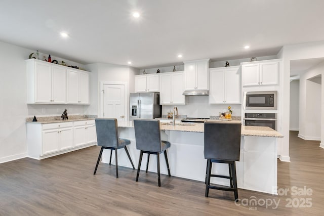 5112 Larewood Dr, Charlotte, NC 28215 - kitchen featuring recessed lighting, white cabinetry, appliances with stainless steel finishes, and a center island with sink