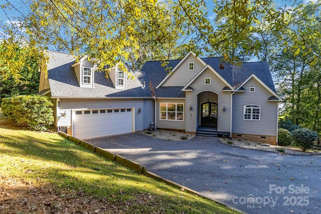 traditional home with a garage, a shingled roof, driveway, and crawl space