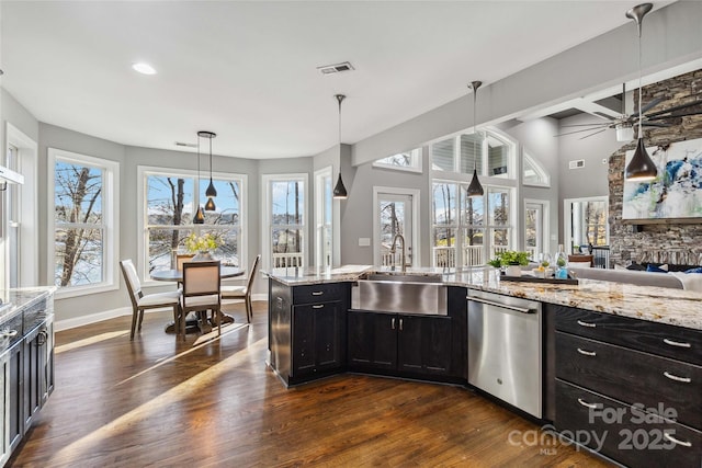 kitchen featuring a sink, dishwasher, dark wood finished floors, a ceiling fan, and visible vents