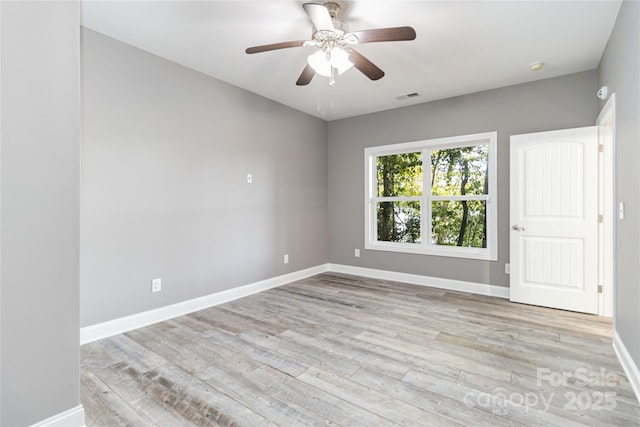 unfurnished room featuring visible vents, baseboards, ceiling fan, and light wood-style floors