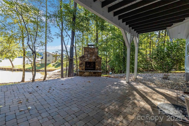 view of patio / terrace with an outdoor stone fireplace