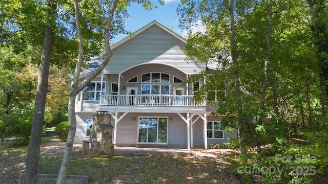 rear view of house with a patio and a wooden deck