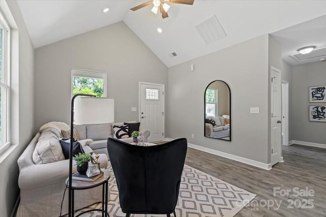 living area with plenty of natural light, ceiling fan, wood finished floors, and visible vents