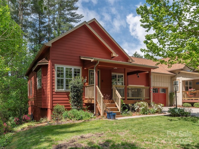 54 Sapling Ln, Waynesville, NC 28786 - view of front facade with covered porch, a front yard, and a garage