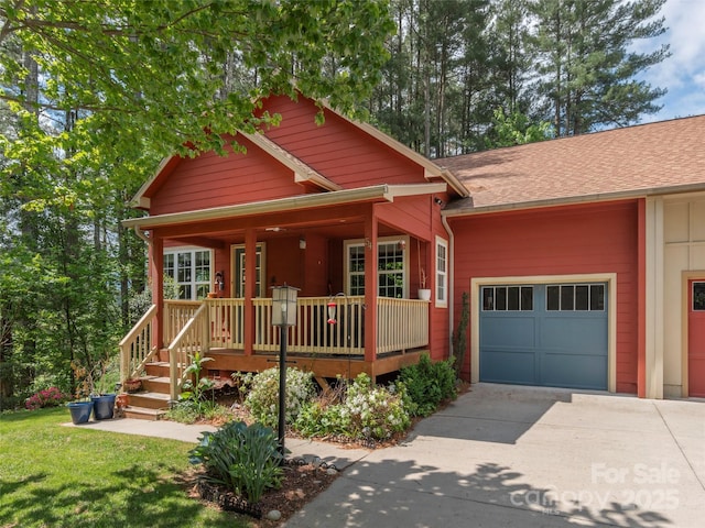 54 Sapling Ln, Waynesville, NC 28786 - view of front of house featuring concrete driveway, an attached garage, a porch, and roof with shingles