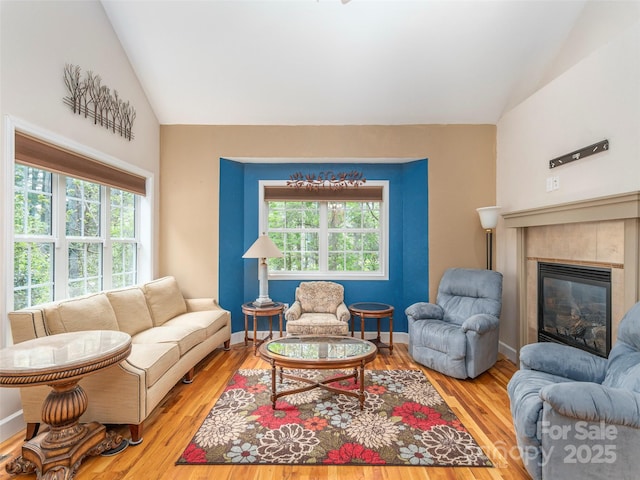 54 Sapling Ln, Waynesville, NC 28786 - living area featuring lofted ceiling, wood finished floors, a tiled fireplace, and baseboards