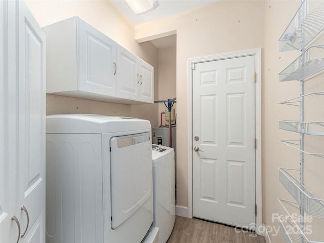54 Sapling Ln, Waynesville, NC 28786 - laundry area featuring cabinet space, washer and clothes dryer, and light wood finished floors