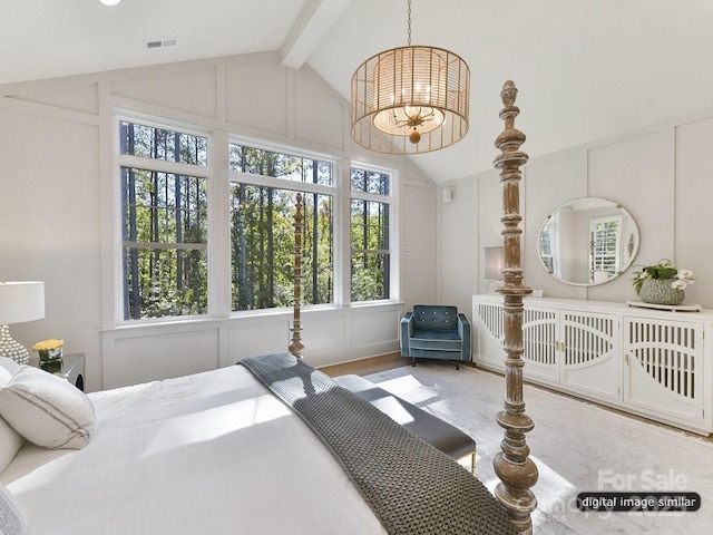 bedroom with visible vents, lofted ceiling with beams, a decorative wall, and a chandelier