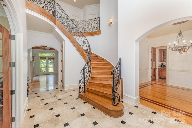 277 Tradition Dr, Mount Gilead, NC 27306 - tiled entryway with stairway, arched walkways, ornamental molding, and a notable chandelier