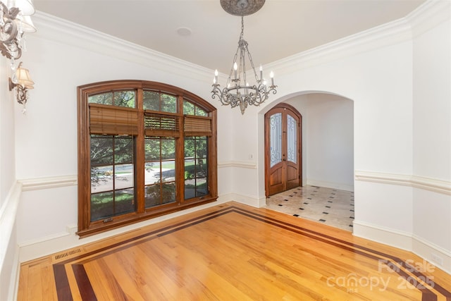 277 Tradition Dr, Mount Gilead, NC 27306 - unfurnished room with arched walkways, a chandelier, french doors, visible vents, and ornamental molding