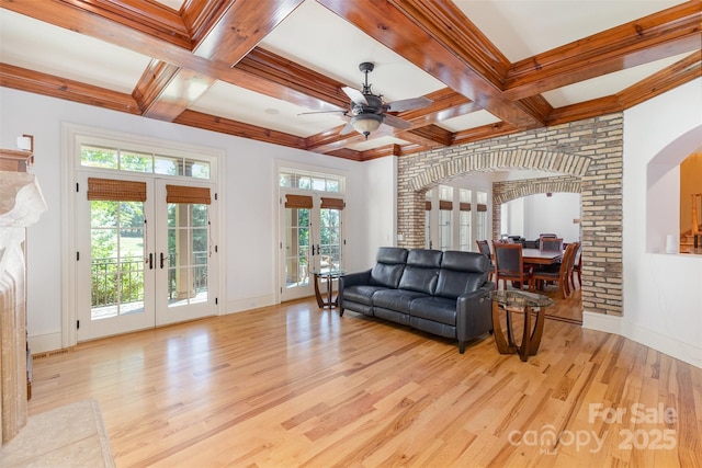 277 Tradition Dr, Mount Gilead, NC 27306 - living area featuring a ceiling fan, french doors, arched walkways, baseboards, and light wood-style flooring