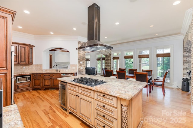277 Tradition Dr, Mount Gilead, NC 27306 - kitchen featuring island exhaust hood, a center island, a sink, beverage cooler, and stainless steel appliances