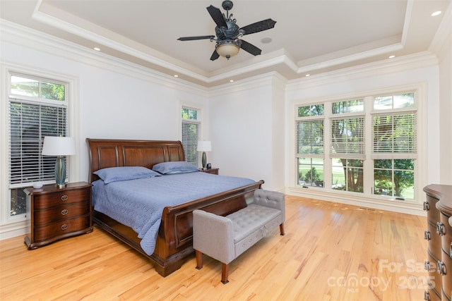 277 Tradition Dr, Mount Gilead, NC 27306 - bedroom with ornamental molding, light wood finished floors, a ceiling fan, and a tray ceiling