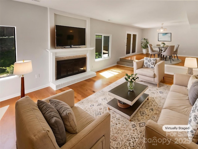 3143 Windbluff Dr, Charlotte, NC 28277 - living area with baseboards, light wood finished floors, and a brick fireplace