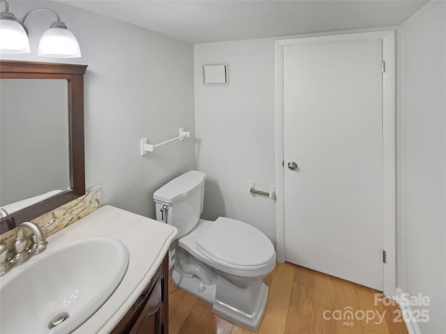 3143 Windbluff Dr, Charlotte, NC 28277 - half bath with toilet, wood finished floors, and vanity