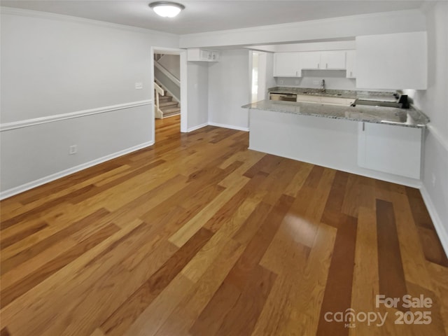 3143 Windbluff Dr, Charlotte, NC 28277 - unfurnished living room with a sink, light wood-style flooring, and stairway