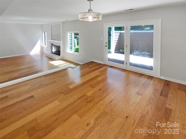 3143 Windbluff Dr, Charlotte, NC 28277 - unfurnished living room with visible vents, baseboards, and wood finished floors