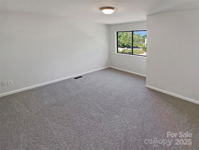 3143 Windbluff Dr, Charlotte, NC 28277 - empty room featuring dark carpet, baseboards, and visible vents