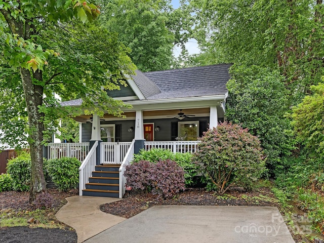 bungalow-style home with a ceiling fan, roof with shingles, and a porch