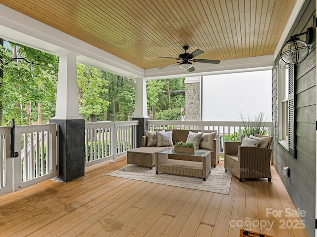 deck featuring outdoor lounge area and ceiling fan