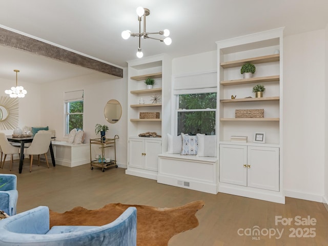 living room featuring a chandelier, wood finished floors, and baseboards