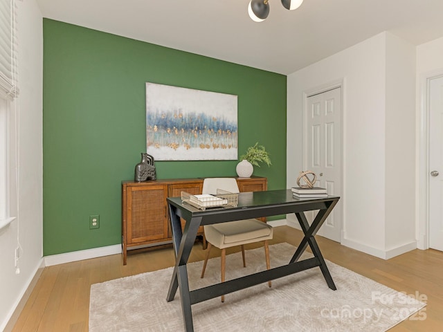 home office with wood finished floors and baseboards