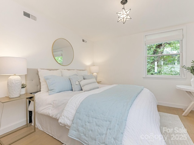 bedroom featuring light wood-style flooring and baseboards