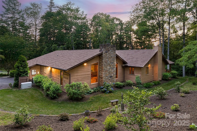 461 Sugar Hollow Rd, Fairview, NC 28730 - view of front of house featuring a chimney, a front lawn, and roof with shingles