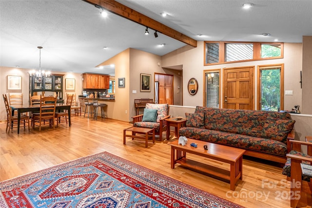 461 Sugar Hollow Rd, Fairview, NC 28730 - living area with light wood finished floors, track lighting, a chandelier, a textured ceiling, and wine cooler