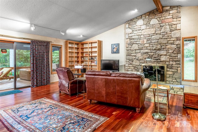 461 Sugar Hollow Rd, Fairview, NC 28730 - living area with wood-type flooring, a stone fireplace, and a textured ceiling