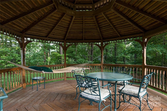 461 Sugar Hollow Rd, Fairview, NC 28730 - wooden terrace with a gazebo, outdoor dining area, and view of scattered trees