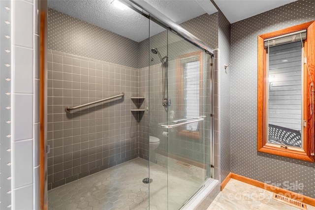 461 Sugar Hollow Rd, Fairview, NC 28730 - bathroom with a stall shower, wallpapered walls, and tile patterned flooring