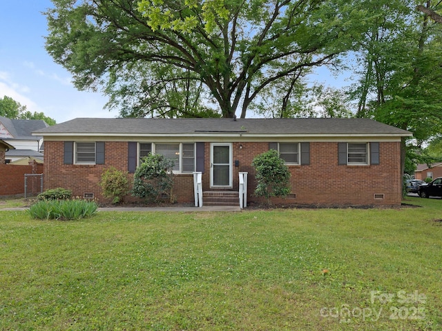 ranch-style home featuring brick siding, crawl space, fence, and a front yard