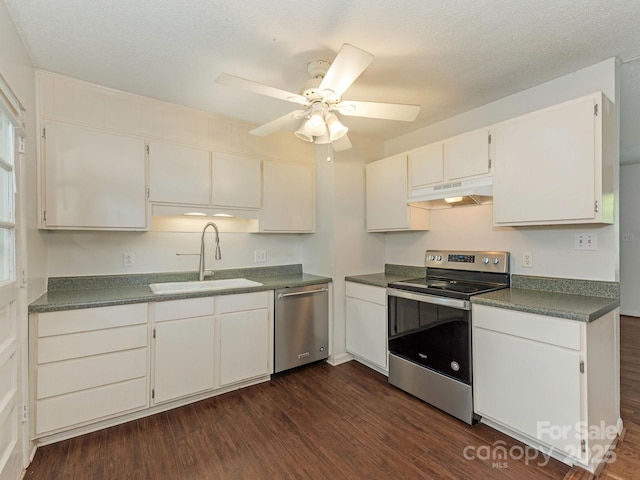 kitchen with under cabinet range hood, ceiling fan, a sink, dark wood-type flooring, and stainless steel appliances