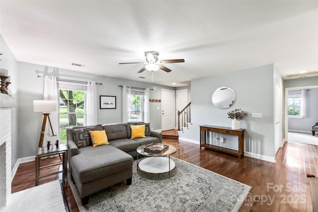 living room featuring a brick fireplace, a ceiling fan, stairway, plenty of natural light, and recessed lighting