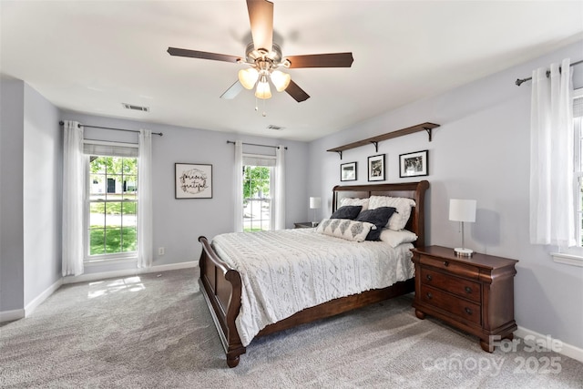 carpeted bedroom featuring baseboards and a ceiling fan