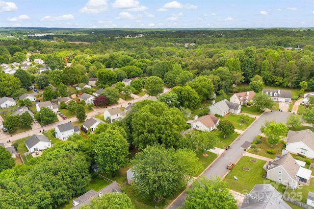 aerial view of residential area with a heavily wooded area