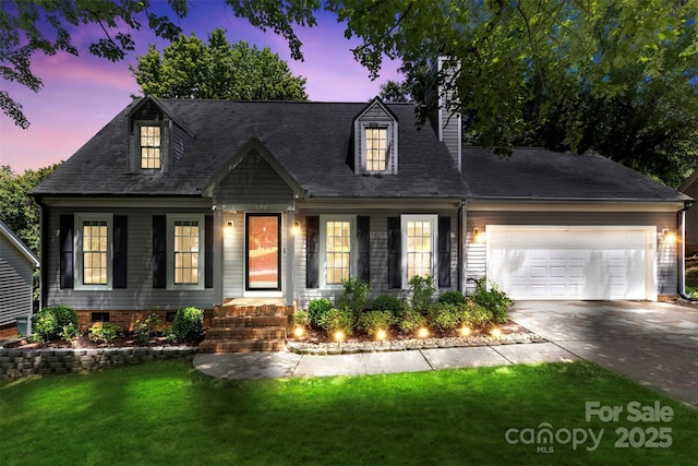 new england style home featuring an attached garage, driveway, a front lawn, and a chimney