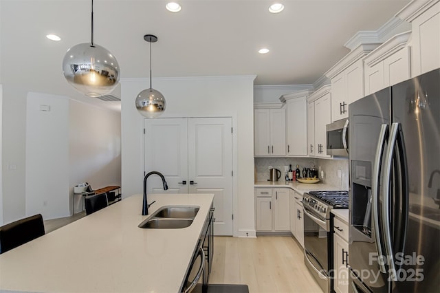 kitchen featuring a sink, light countertops, stainless steel appliances, recessed lighting, and decorative backsplash