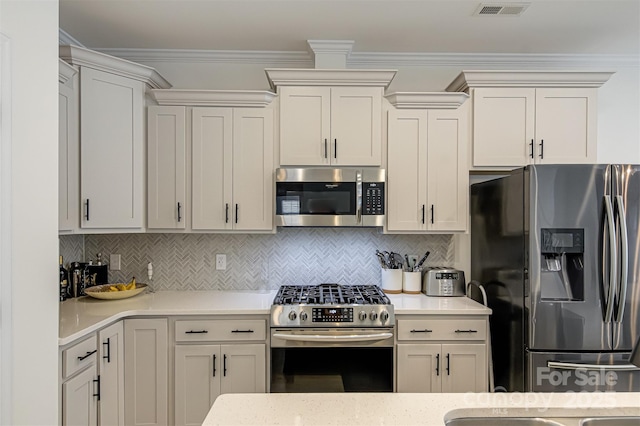 kitchen with visible vents, light countertops, tasteful backsplash, and stainless steel appliances