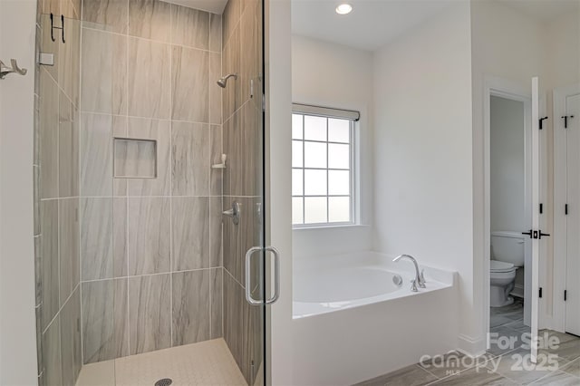 bathroom featuring a garden tub, a stall shower, baseboards, toilet, and recessed lighting