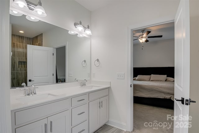 ensuite bathroom featuring double vanity, ceiling fan, a sink, and ensuite bath