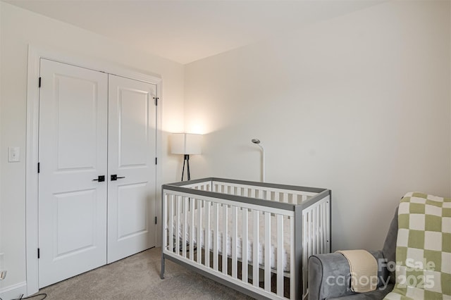 bedroom featuring a closet, carpet flooring, and a nursery area