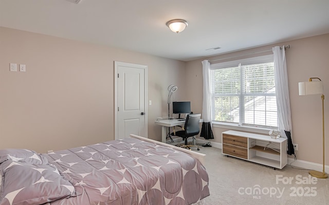 carpeted bedroom with baseboards and visible vents