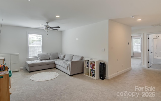 living room featuring visible vents, light carpet, baseboards, recessed lighting, and a ceiling fan