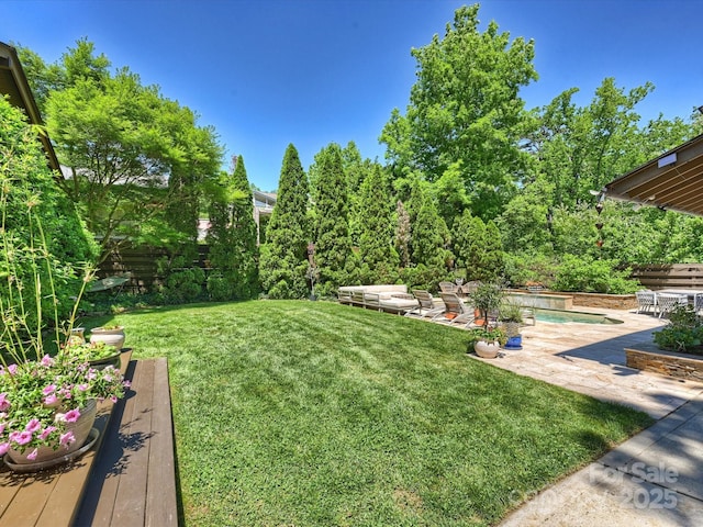 view of yard featuring a patio area and an outdoor pool